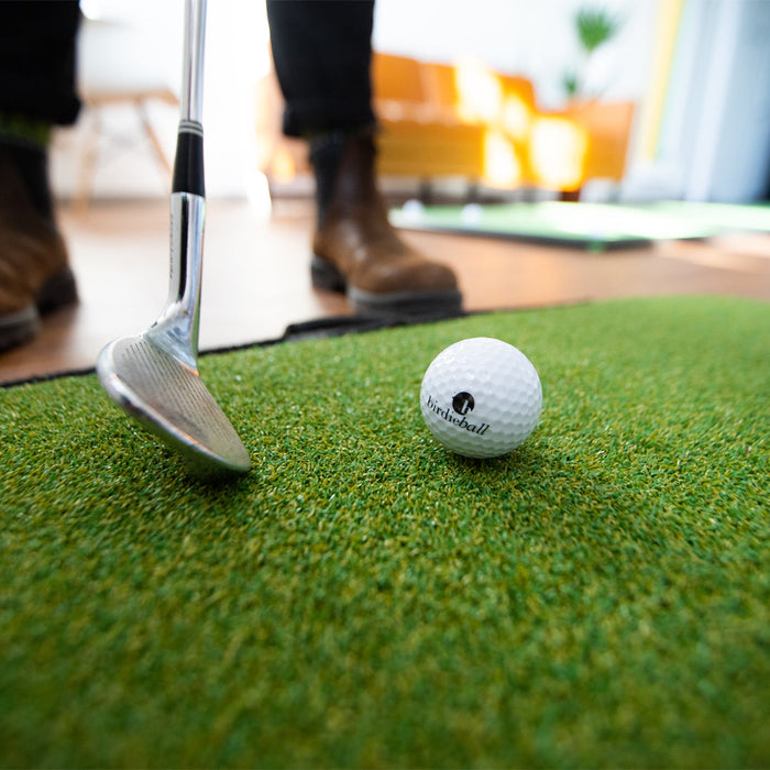 person chipping on a practice golf turf