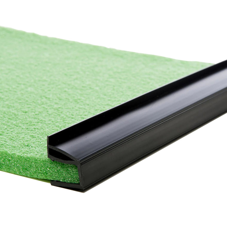 Close-up of BirdieBall Bumpers (Set of 2)—black plastic edging strips fitted onto the edge of a green BirdieBall Putting Green sheet, serving as a golf ball stop for matting or flooring installations.